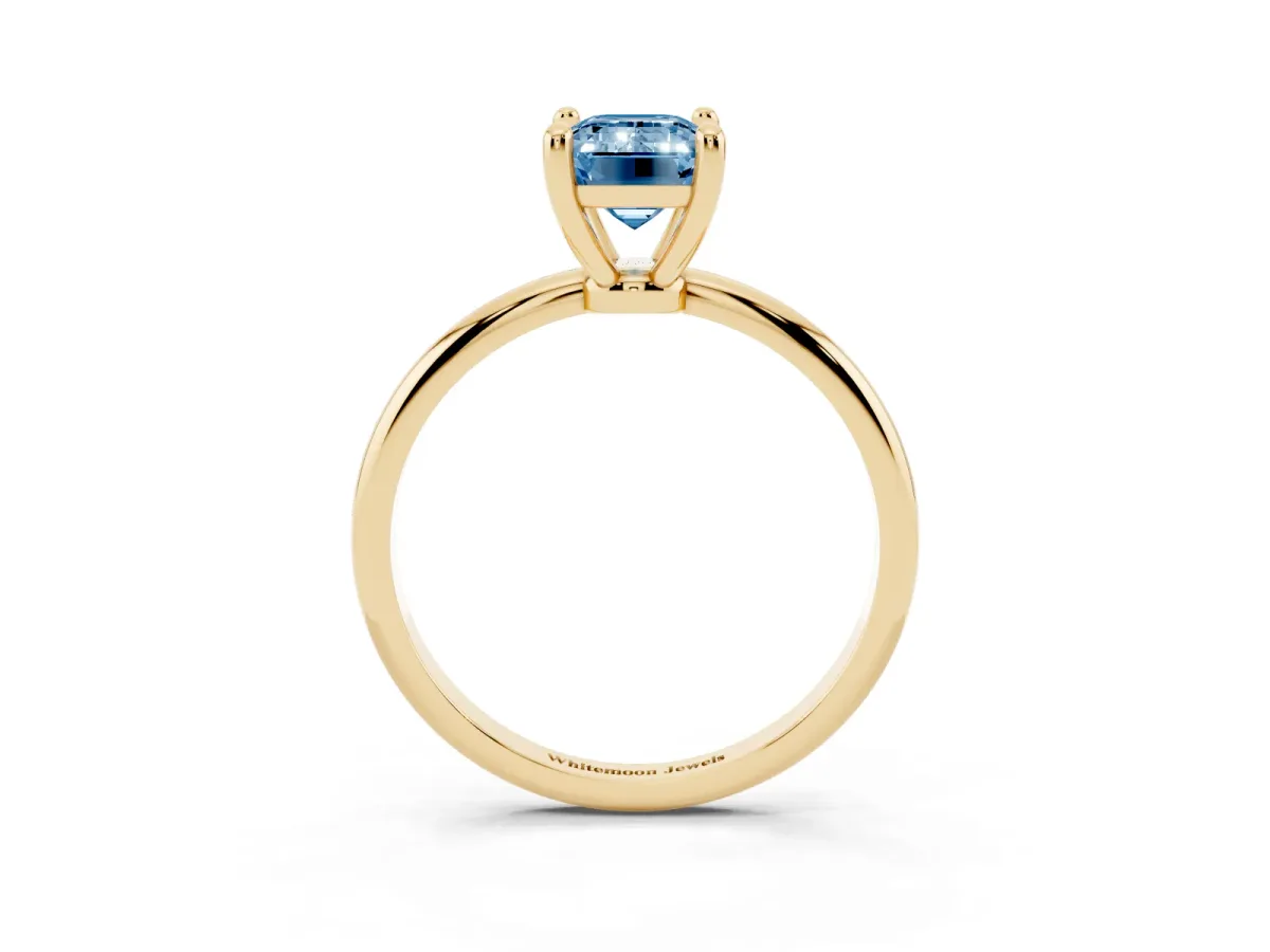 Fancy Blue Emerald Cut Solitaire Diamond Ring with 4-Prong Setting on a Classic Band Yellow gold