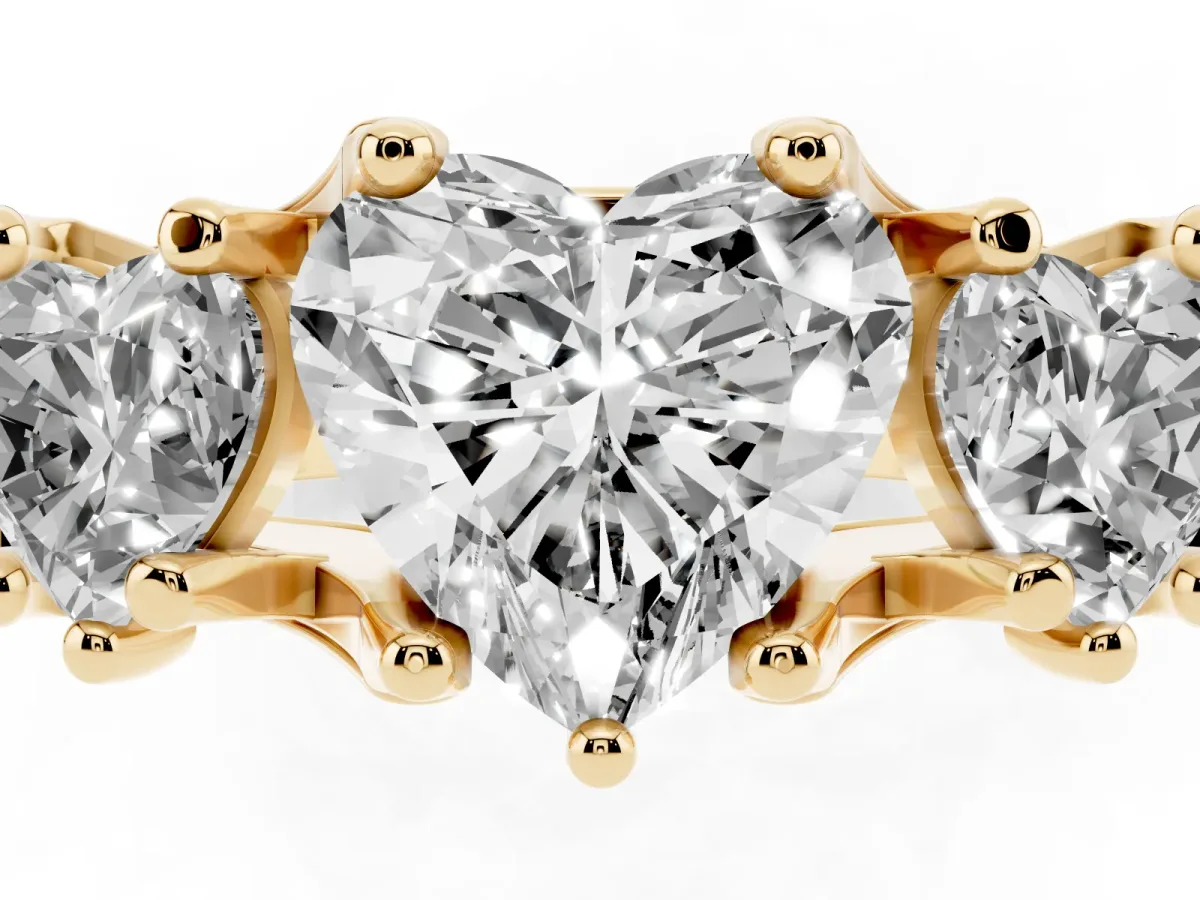 Heart Cut Diamond Three-Stone Ring with Channel Set Band and Four-Prong Setting Yellow gold