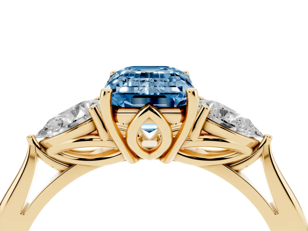 Fancy Blue Three-Stone Emerald Cut Brilliant Diamond Solitaire Ring with Tapered Band and Four-Prong Setting Yellow gold