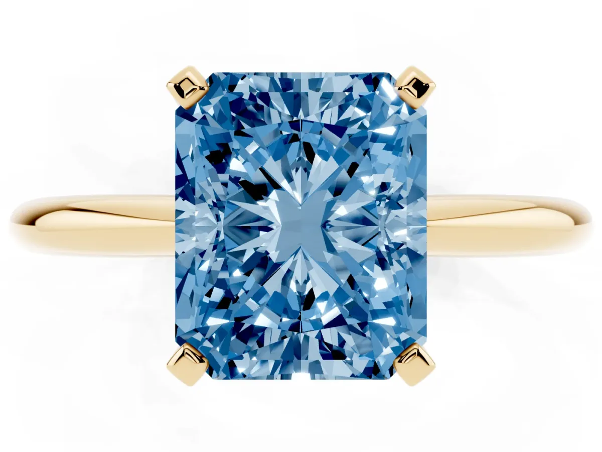 Fancy Blue Radiant Cut Diamond Solitaire Ring with Prong Setting and Classic Band Yellow gold