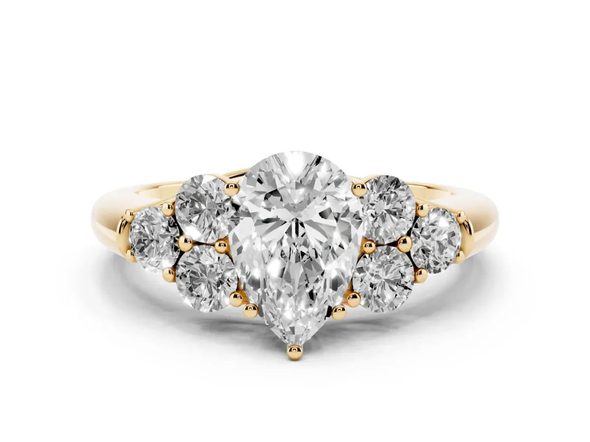 Pear Cut Cut Diamond Cluster Ring with Round Accent Stones and Prong Setting on a Classic Band Yellow gold