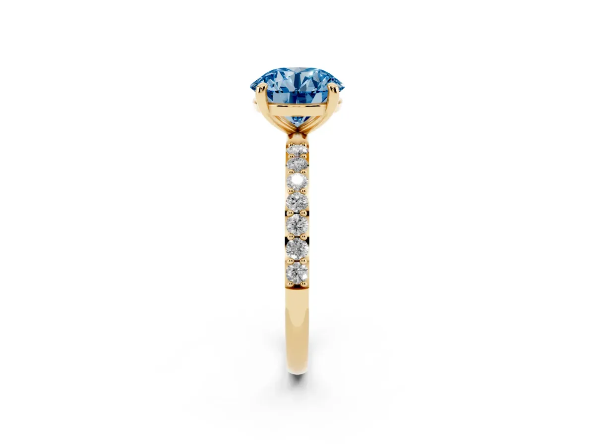 Fancy Blue Round Cut Diamond Solitaire Ring with Round Pavé Band and Prong Setting Yellow gold