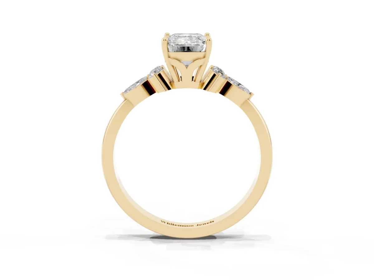 Emerald Cut Brilliant Diamond Solitaire Ring with Pear Side Stones and Four-Prong Setting Yellow gold