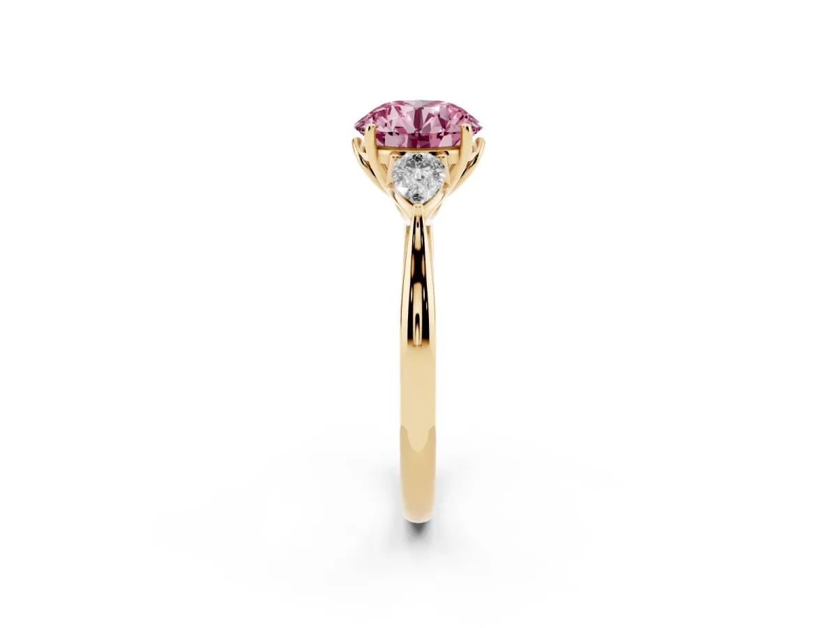 Fancy Pink Three-Stone Round Cut Brilliant Diamond Solitaire Ring with Tapered Band and Four-Prong Setting Yellow gold