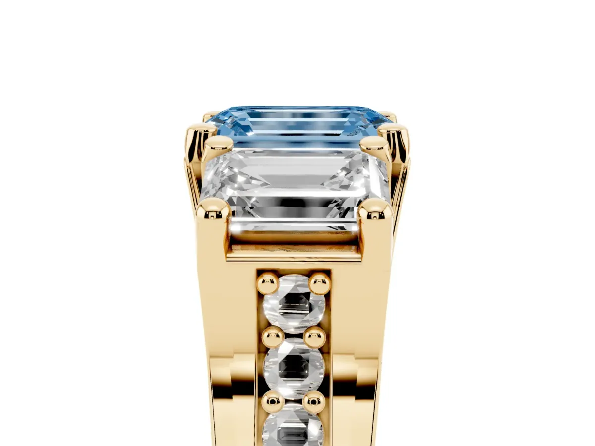 Fancy Blue Emerald Cut Diamond Three-Stone Ring with Channel Set Band and Four-Prong Setting Yellow gold