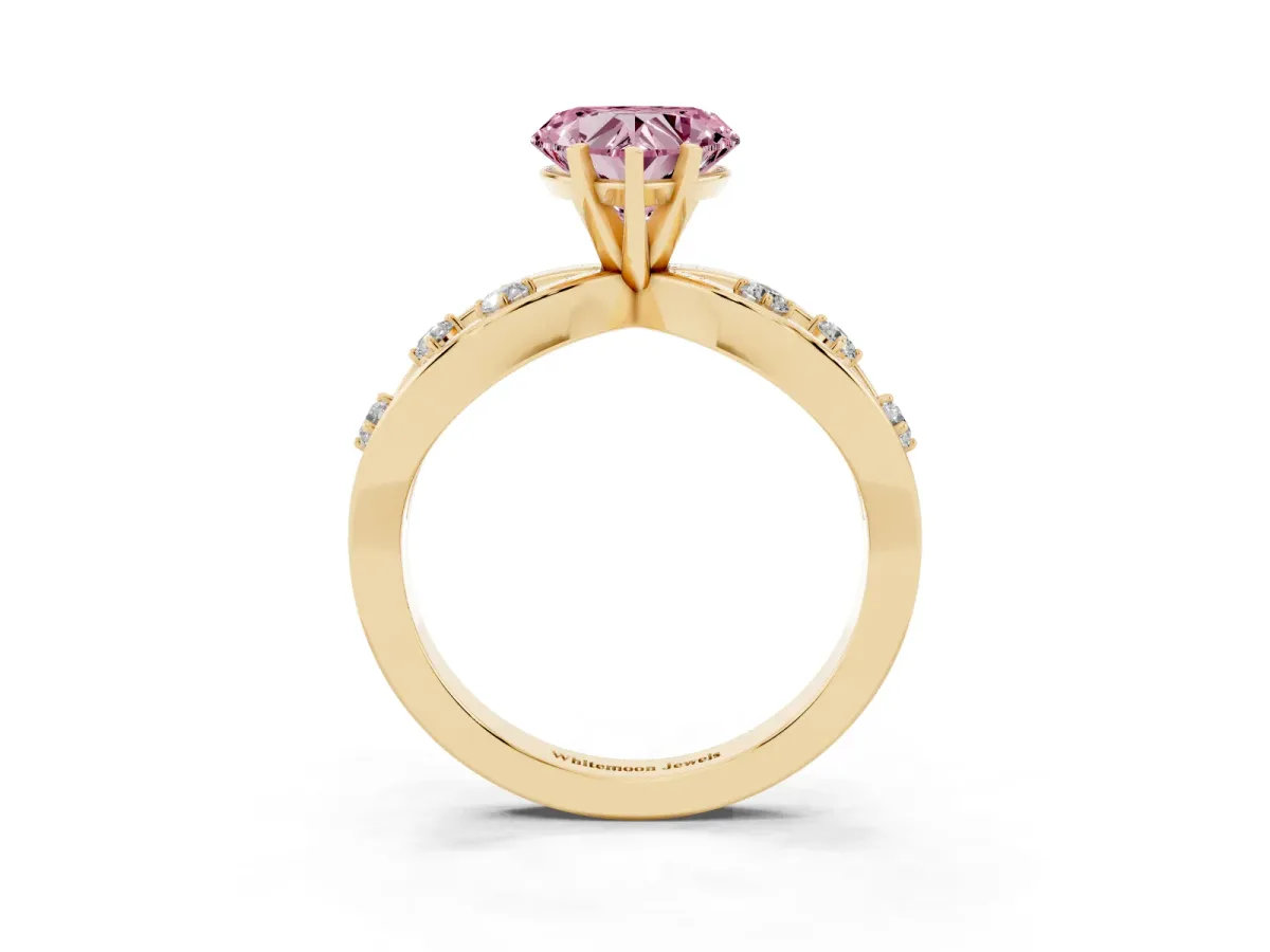 Fancy Pink Heart Cut Cut Solitaire Diamond with Side Stones on Criss-Cross Band and Four-Prong Setting Yellow gold