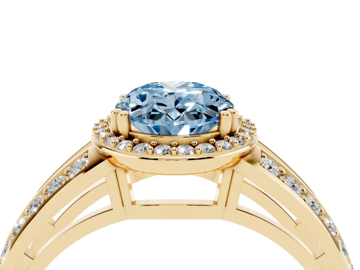 Fancy Blue Oval Cut Diamond Halo Ring with Split Shank Pavé Band and Four-Prong Setting Yellow gold