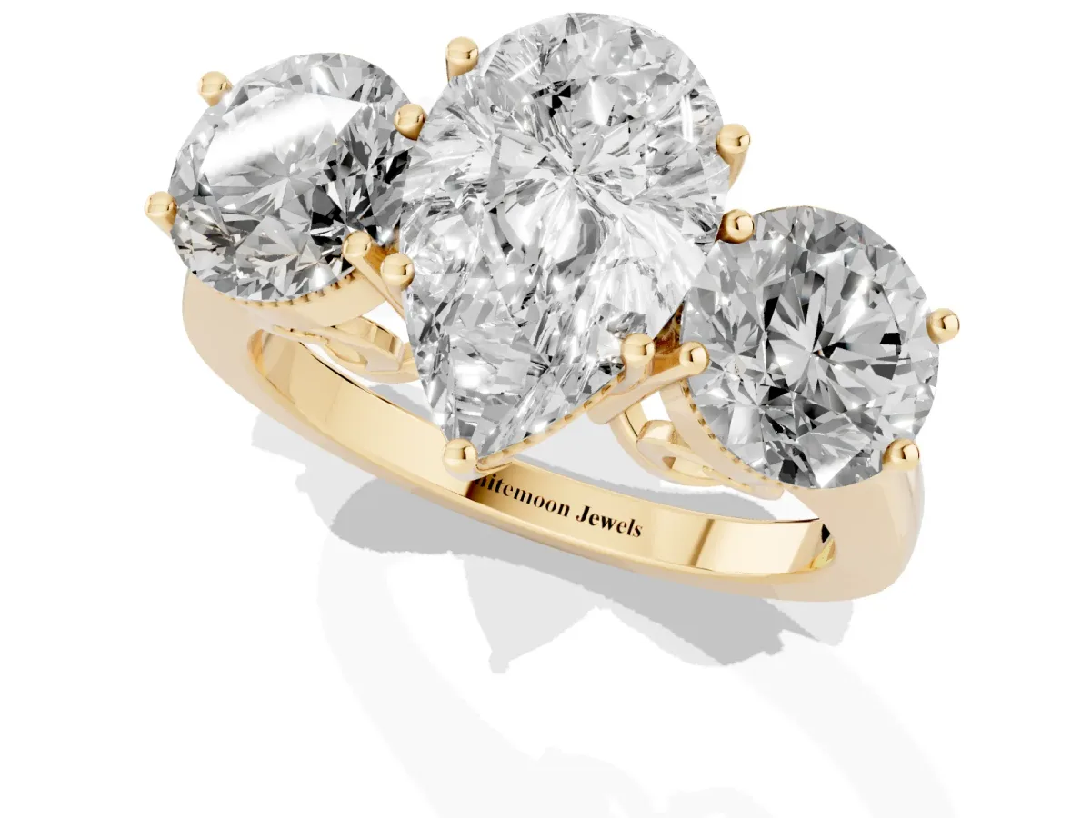 Three-Stone Pear Cut Diamond Engagement Ring with Prong Setting on a Classic Band Yellow gold