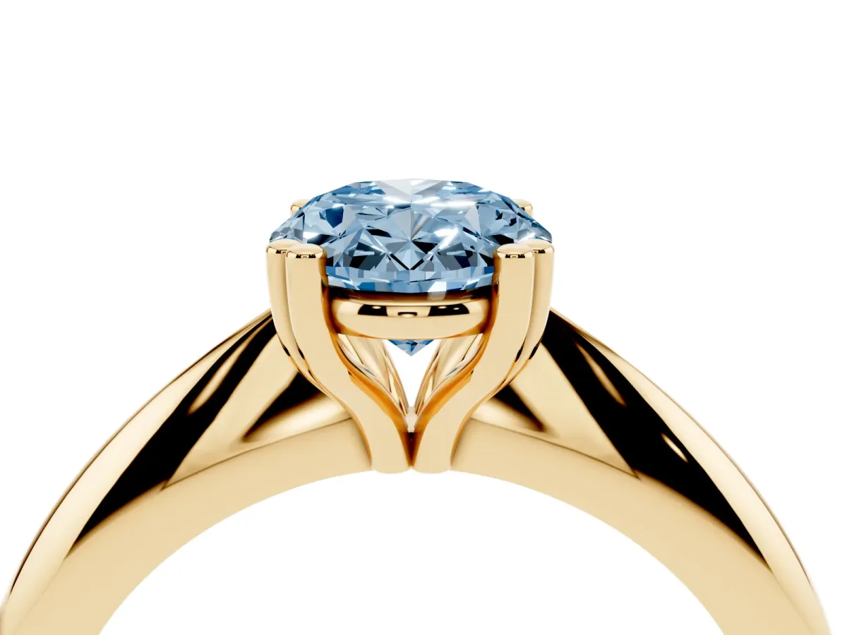 Fancy Blue Oval Cut Cut Solitaire Engagement Ring with Tapered Band and Four-Prong Setting Yellow gold