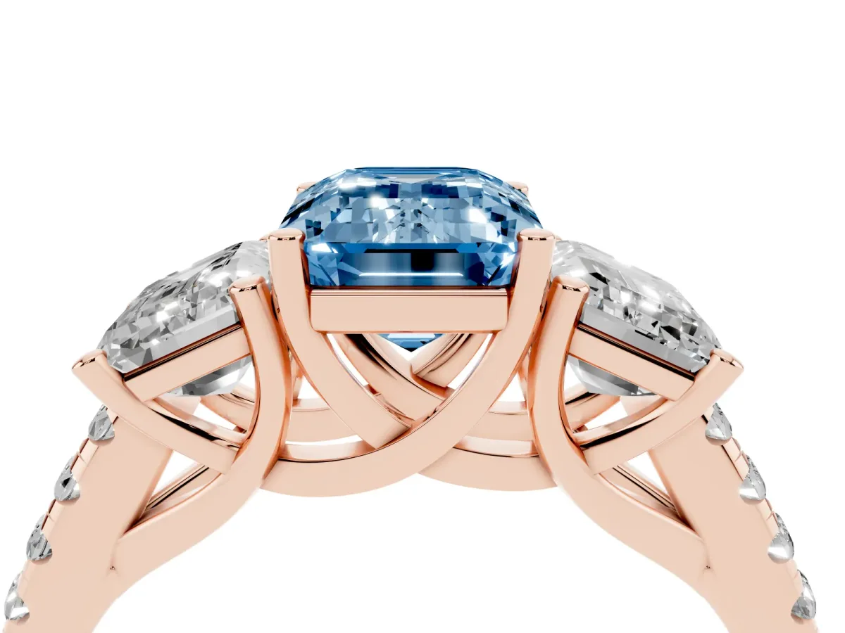 Fancy Blue Three-Stone Emerald Cut Diamond Ring with Round Pavé Band and Prong Setting Rose gold