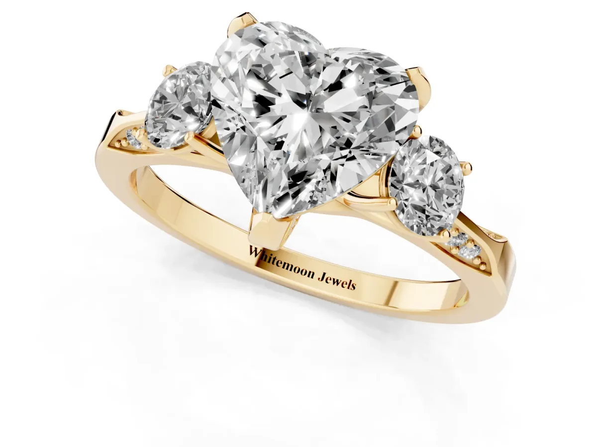 Heart Cut Brilliant Three-Stone Diamond Ring with Pavé Band and Four-Prong Setting Yellow gold