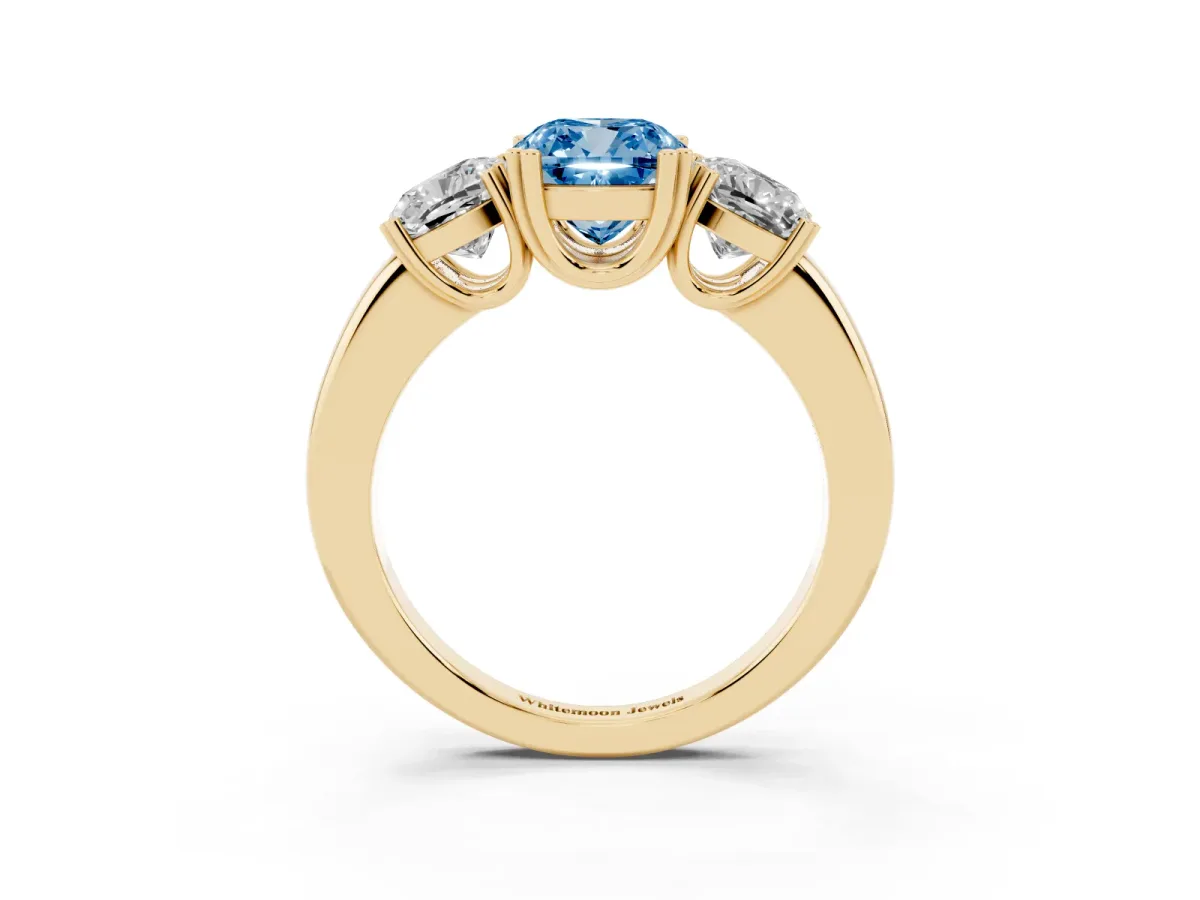 Fancy Blue Three-Stone Cushion Cut Cut Diamond Ring with Channel Set Band and Four-Prong Setting Yellow gold