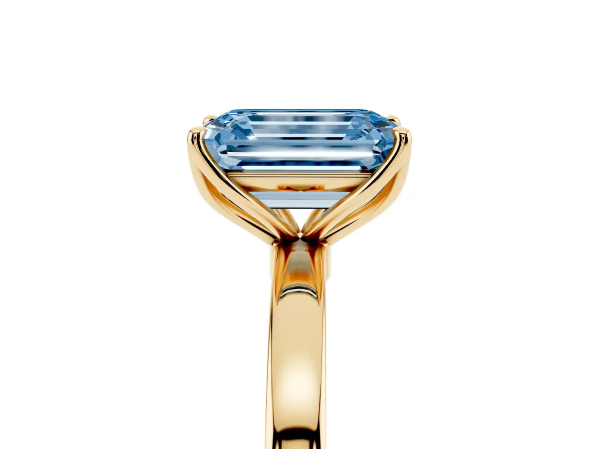 Fancy Blue Emerald Cut Diamond Solitaire Ring with Thin Band and Prong Setting Yellow gold