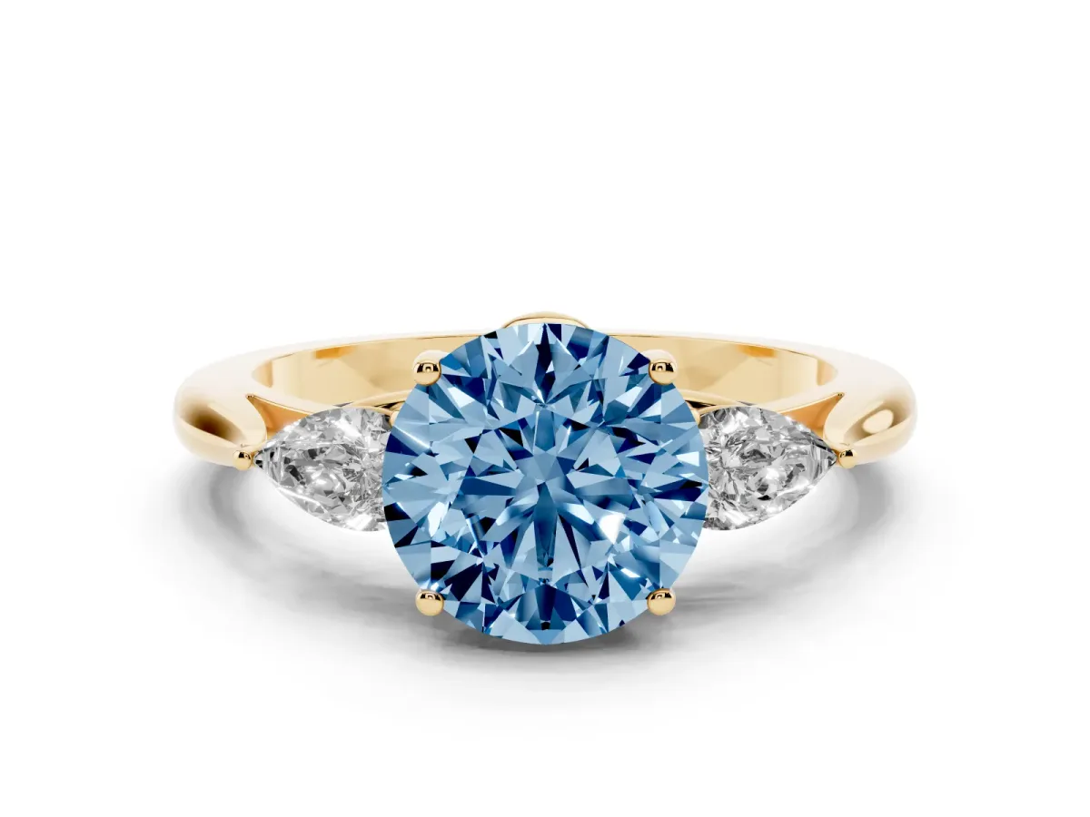 Fancy Blue Three-Stone Round Cut Diamond Ring with Pear Side Stones in Four-Prong Setting Yellow gold
