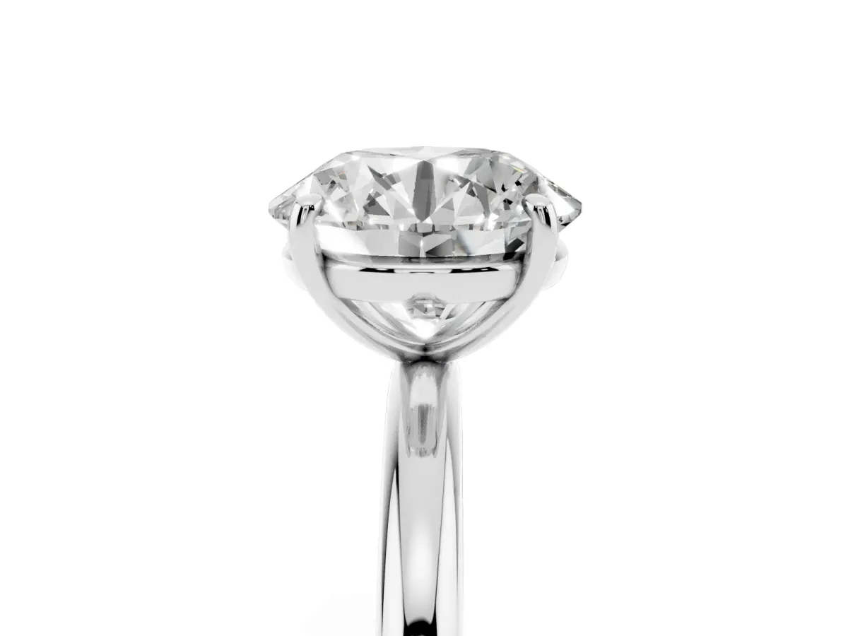 Round Cut Solitaire Diamond Ring with Four-Prong Setting on a Plain Band Platinum