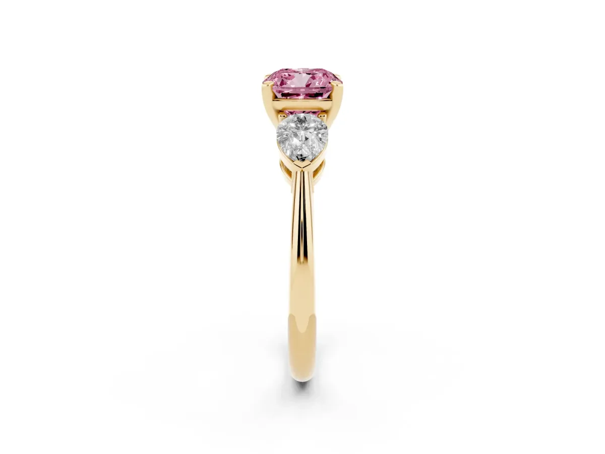 Fancy Pink Three-Stone Cushion Cut Diamond Ring with Pear Side Stones and Four-Prong Setting Yellow gold