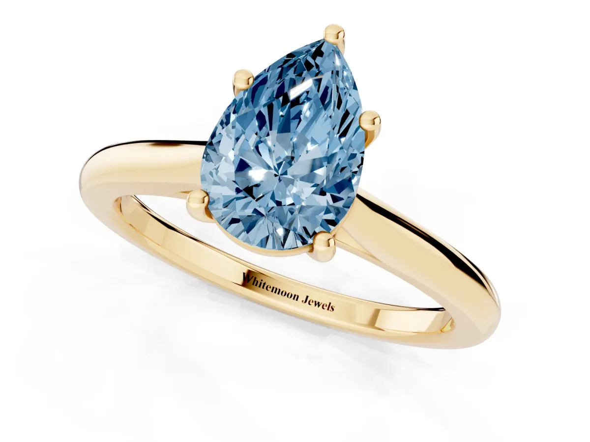 Fancy Blue Pear Cut Cut Solitaire Ring with Cathedral Band and Four-Prong Setting Yellow gold