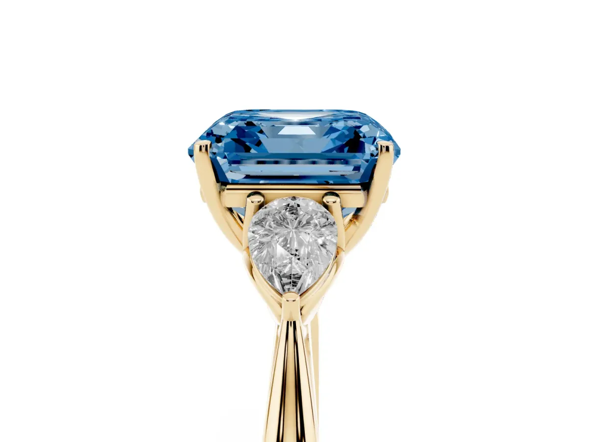 Fancy Blue Three-Stone Asscher Cut Diamond Ring with Pear Side Stones in Four-Prong Setting Yellow gold