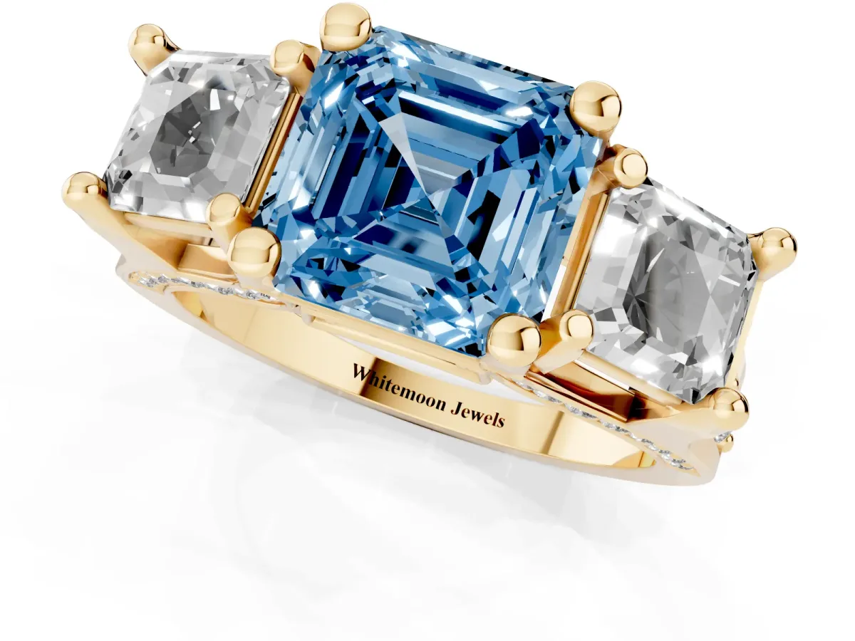 Fancy Blue Asscher Cut Diamond Three-Stone Ring with Channel Set Band and Four-Prong Setting Yellow gold