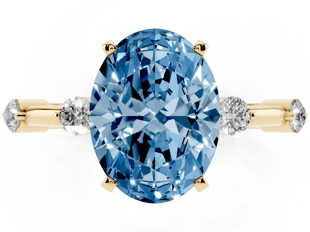 Fancy Blue Oval Cut Solitaire Diamond Ring with Bezel Set Side Stones and Prong Setting Yellow gold