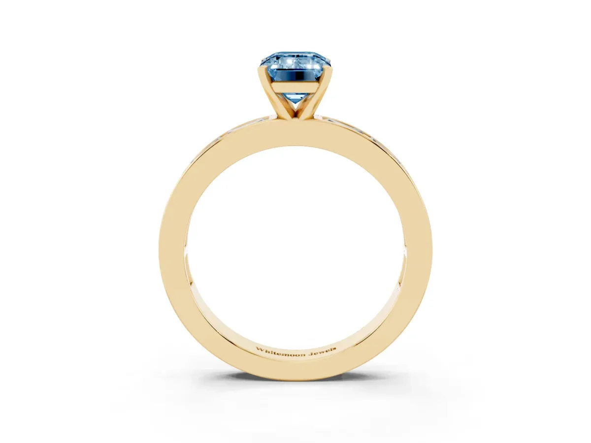 Fancy Blue Emerald Cut Solitaire Diamond Ring with Channel-Set Baguette Band and Four-Prong Setting Yellow gold