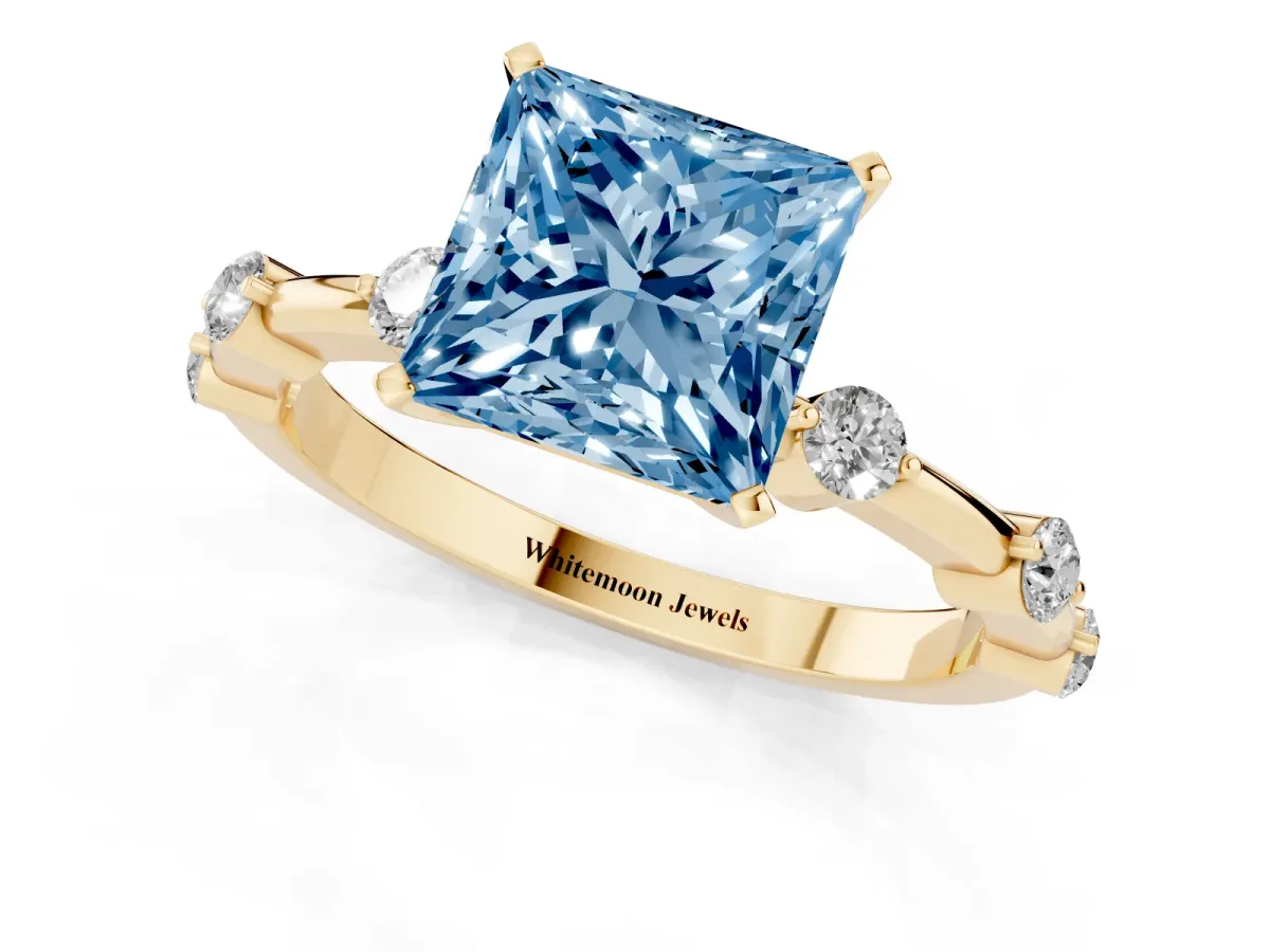 Fancy Blue Princess Cut Solitaire Diamond Ring with Bezel Set Side Stones and Prong Setting Yellow gold
