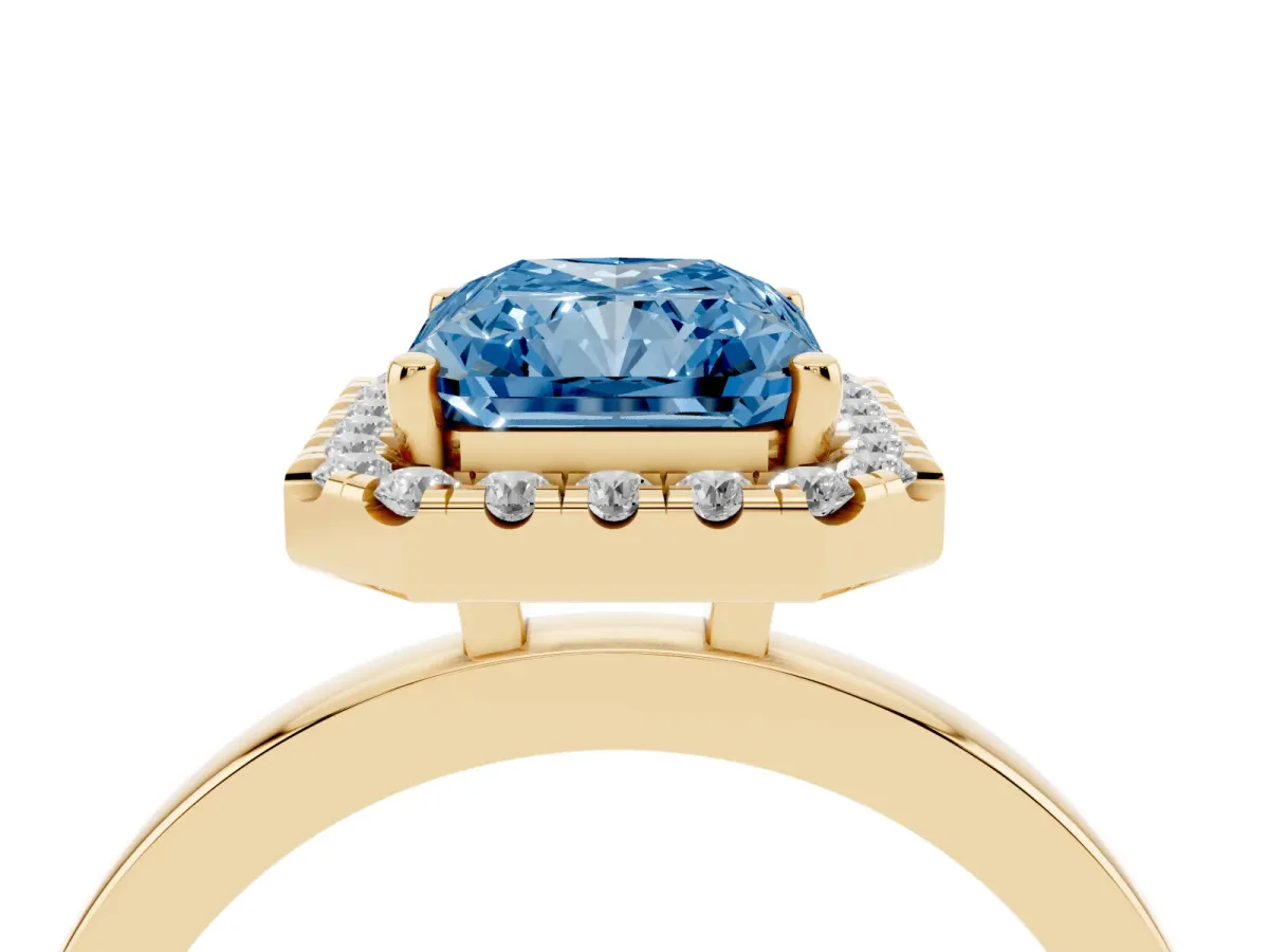 Fancy Blue Radiant Cut Halo Diamond Solitaire with Pavé Band and Four-Prong Setting Yellow gold