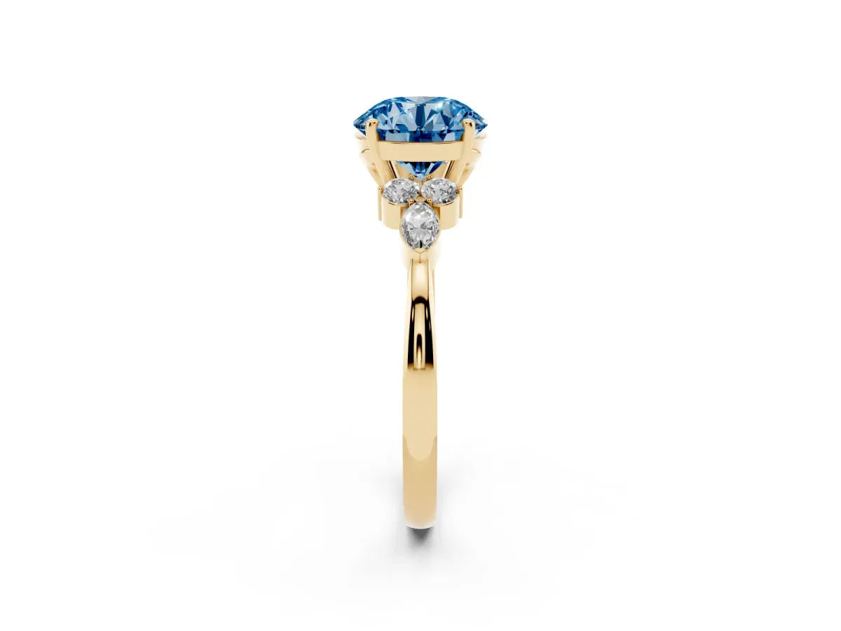 Fancy Blue Round Cut Brilliant Diamond Solitaire Ring with Pear Side Stones and Four-Prong Setting Yellow gold