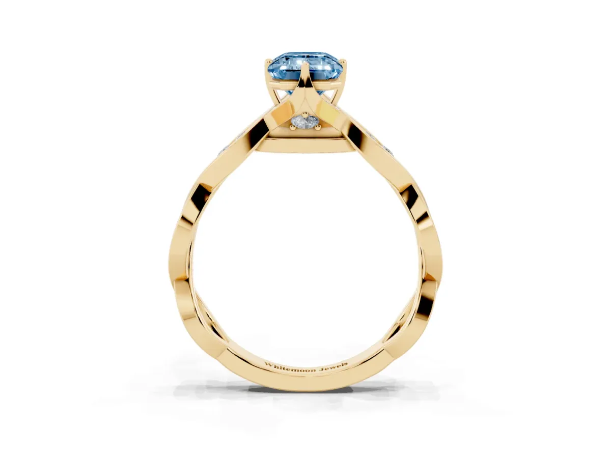 Fancy Blue Emerald Cut Solitaire Twist Band with Leaf Prong Setting Yellow gold