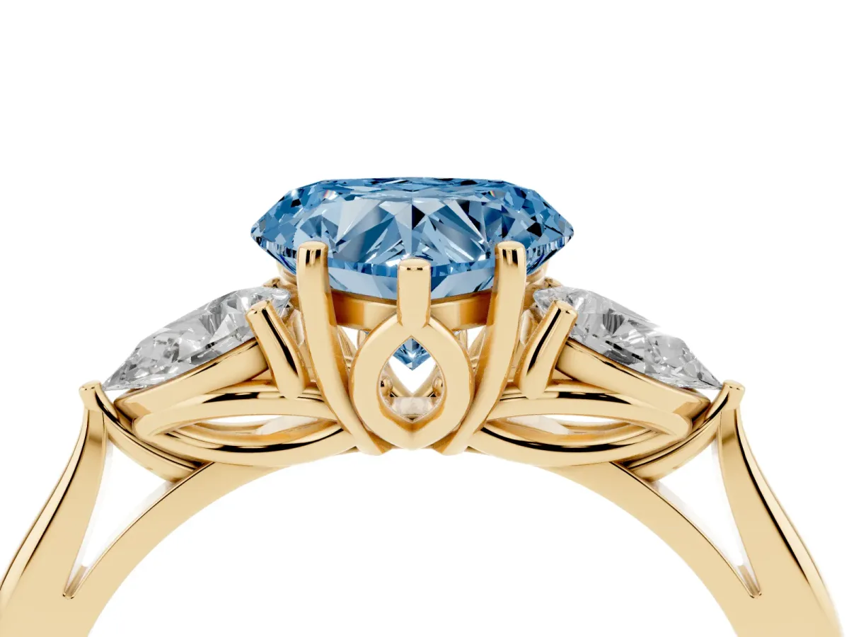 Fancy Blue Heart Cut Diamond Three-Stone Ring with Pear Side Stones and Prong Setting Yellow gold