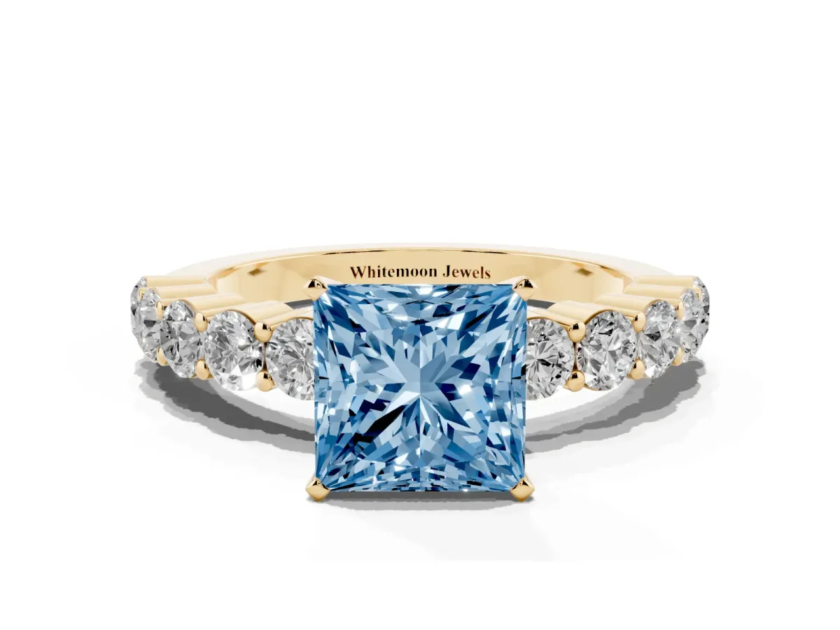 Fancy Blue Princess Cut Diamond Solitaire Ring with Shared Prong Round Side Stones Yellow gold