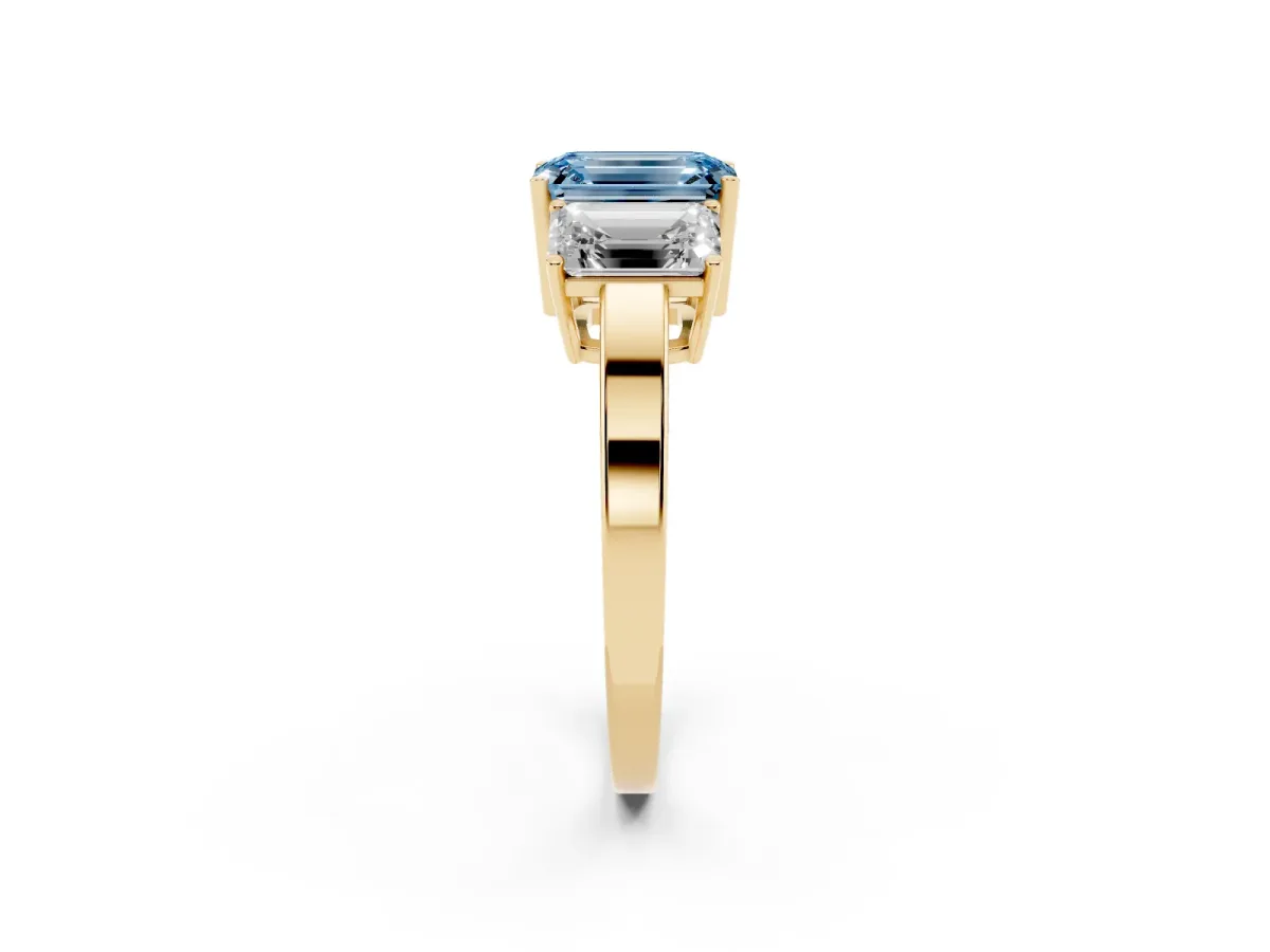 Fancy Blue Three-Stone Emerald Cut Cut Diamond Engagement Ring with Flat Band and Four-Prong Setting Yellow gold