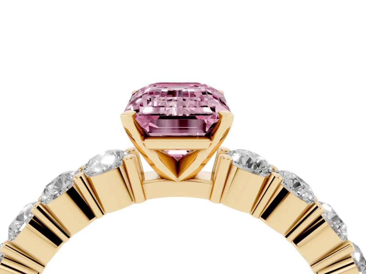 Fancy Pink Emerald Cut Diamond Solitaire Ring with Shared Prong Round Side Stones Yellow gold