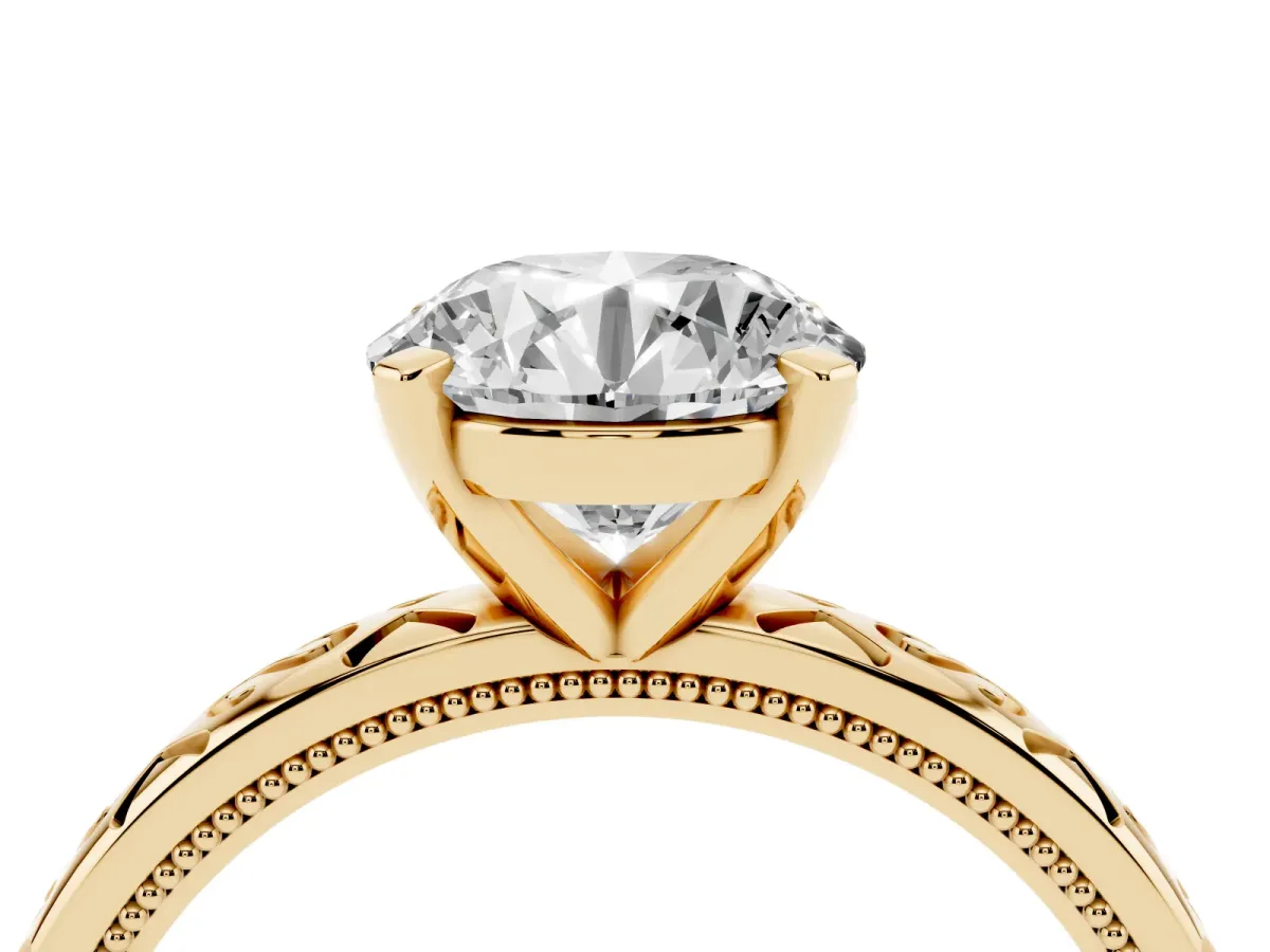 Round Cut Solitaire Engagement Ring with Scrollwork Band and Four-Prong Setting Yellow gold