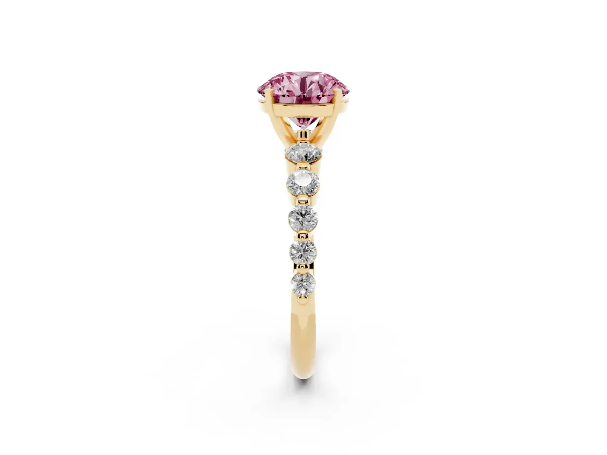 Fancy Pink Round Cut Solitaire Diamond Ring with Pave Band and Four-Prong Setting Yellow gold