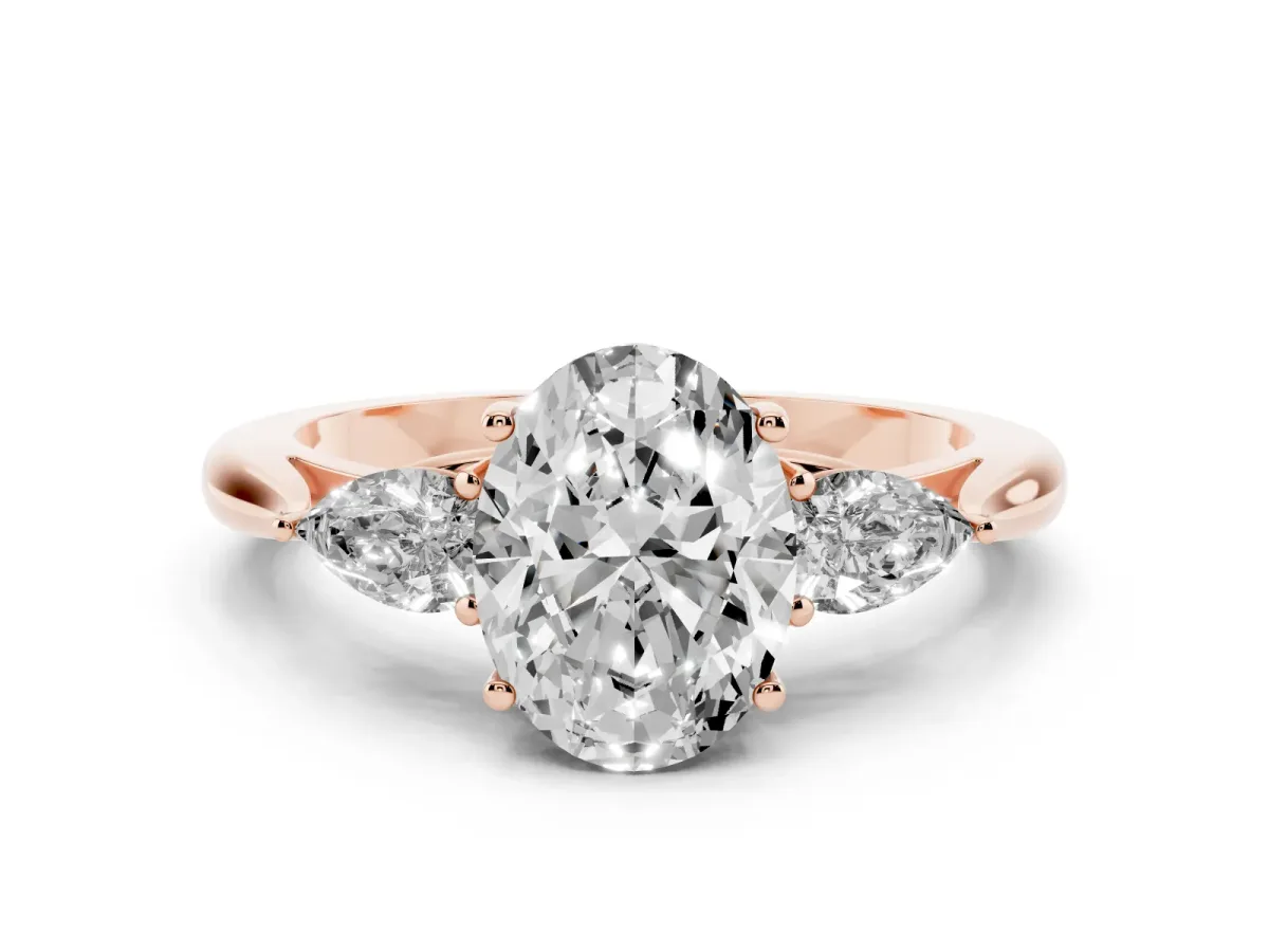 Three-Stone Oval Cut Diamond Ring with Pear Side Stones in Four-Prong Setting Rose gold