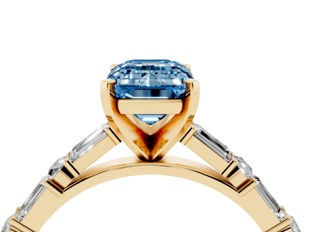 Fancy Blue Emerald Cut Diamond Solitaire with Side Baguettes and Channel Set Band Yellow gold