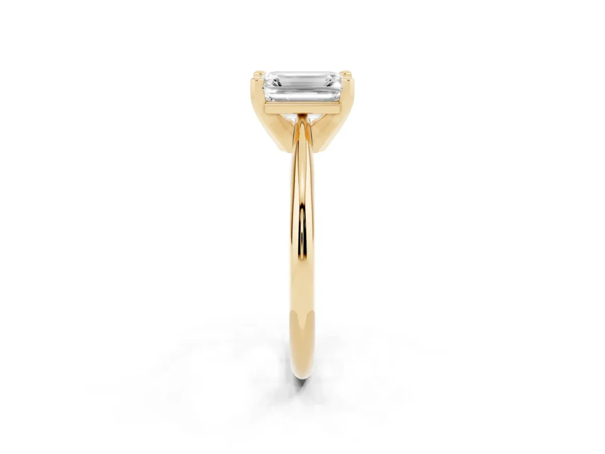 Emerald Cut Cut Solitaire Ring with Four-Prong Setting on a Classic Band Yellow gold