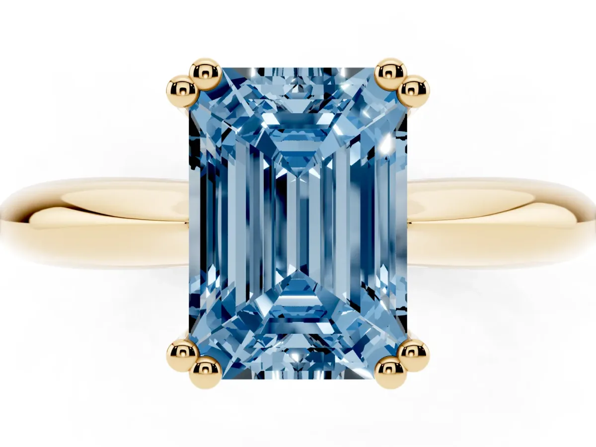 Fancy Blue Emerald Cut Cut Solitaire Engagement Ring with Tapered Band and Four-Prong Setting Yellow gold