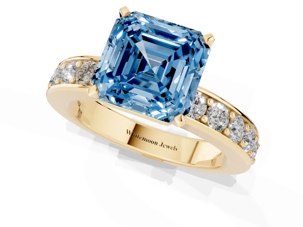 Fancy Blue Asscher Cut Diamond Engagement Ring with Channel Set Round Band and Prong Setting Yellow gold