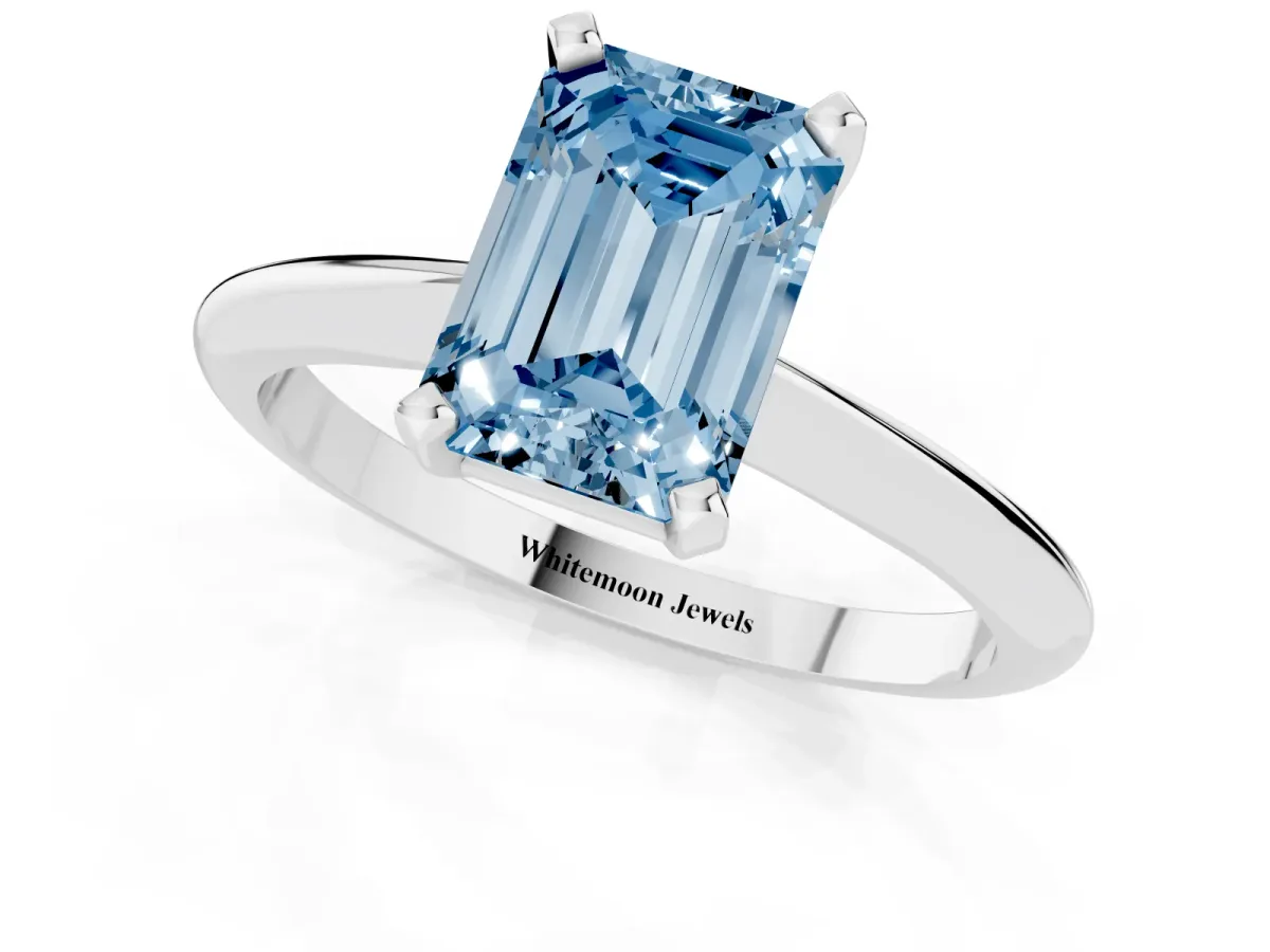 Fancy Blue Emerald Cut Cut Solitaire Ring with Four-Prong Setting on a Classic Band White gold