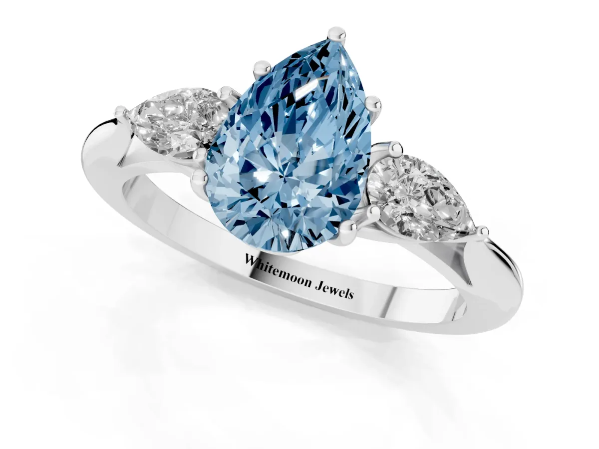 Fancy Blue Pear Cut Diamond Three-Stone Ring with Pear Side Stones and Prong Setting Platinum