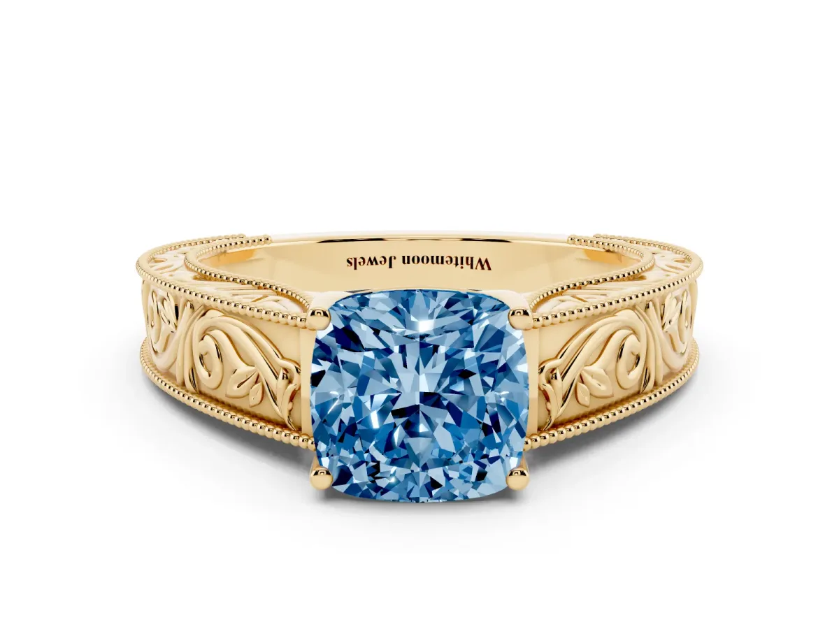Fancy Blue Cushion Cut Diamond Solitaire Ring with Engraved Band and Four-Prong Setting Yellow gold