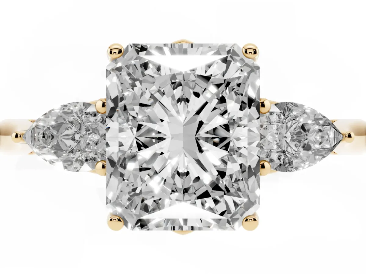 Three-Stone Radiant Cut Diamond Ring with Pear Side Stones in Four-Prong Setting Yellow gold