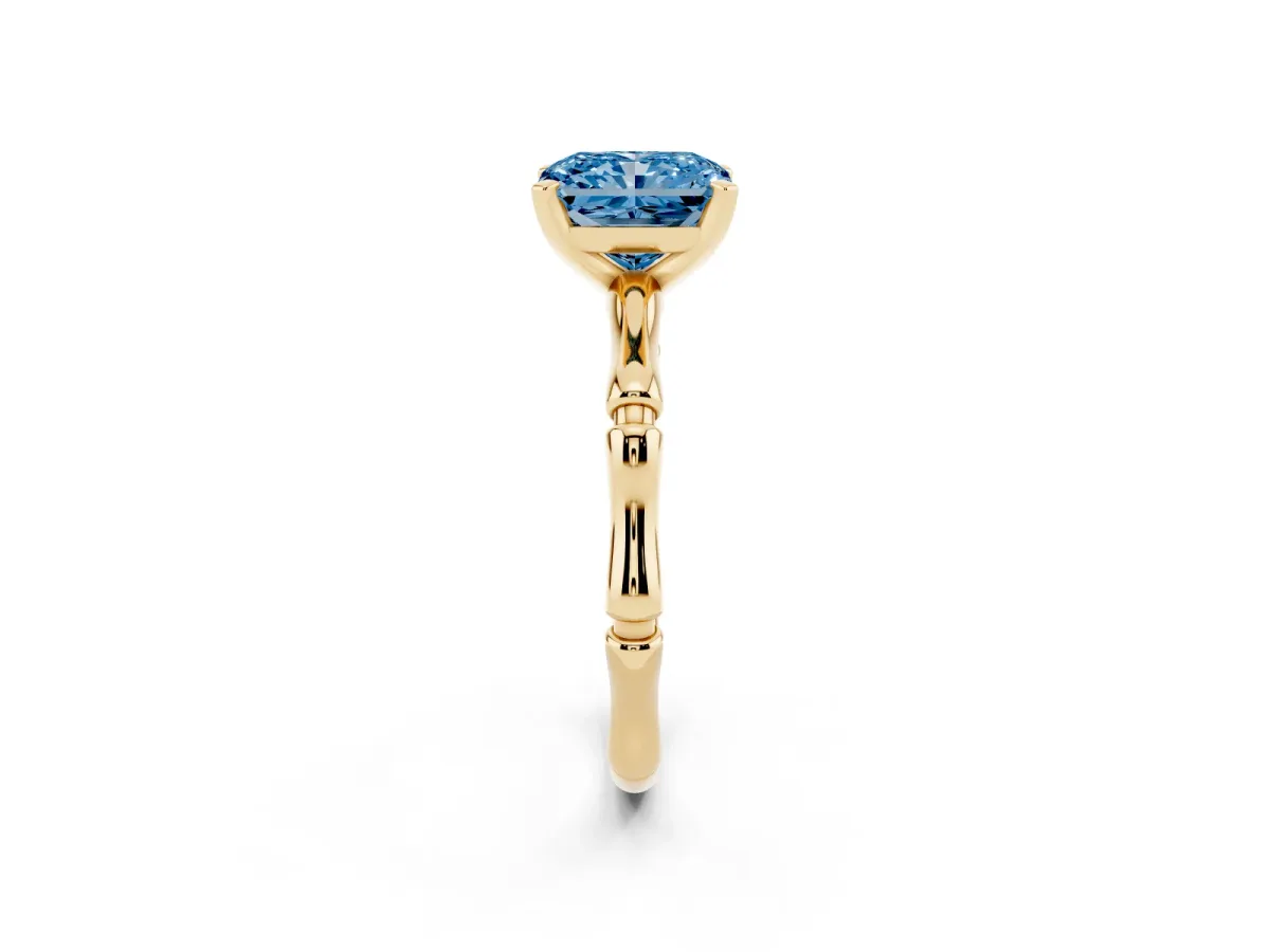 Fancy Blue Radiant Cut Solitaire Diamond Ring with Bamboo Band and Four-Prong Setting Yellow gold