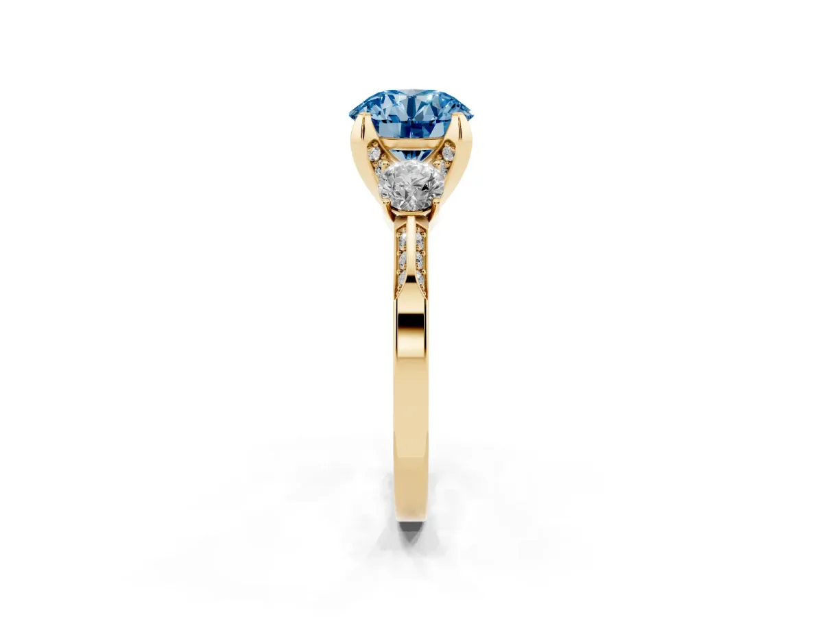 Fancy Blue Round Cut Brilliant Three-Stone Diamond Ring with Pavé Band and Four-Prong Setting Yellow gold