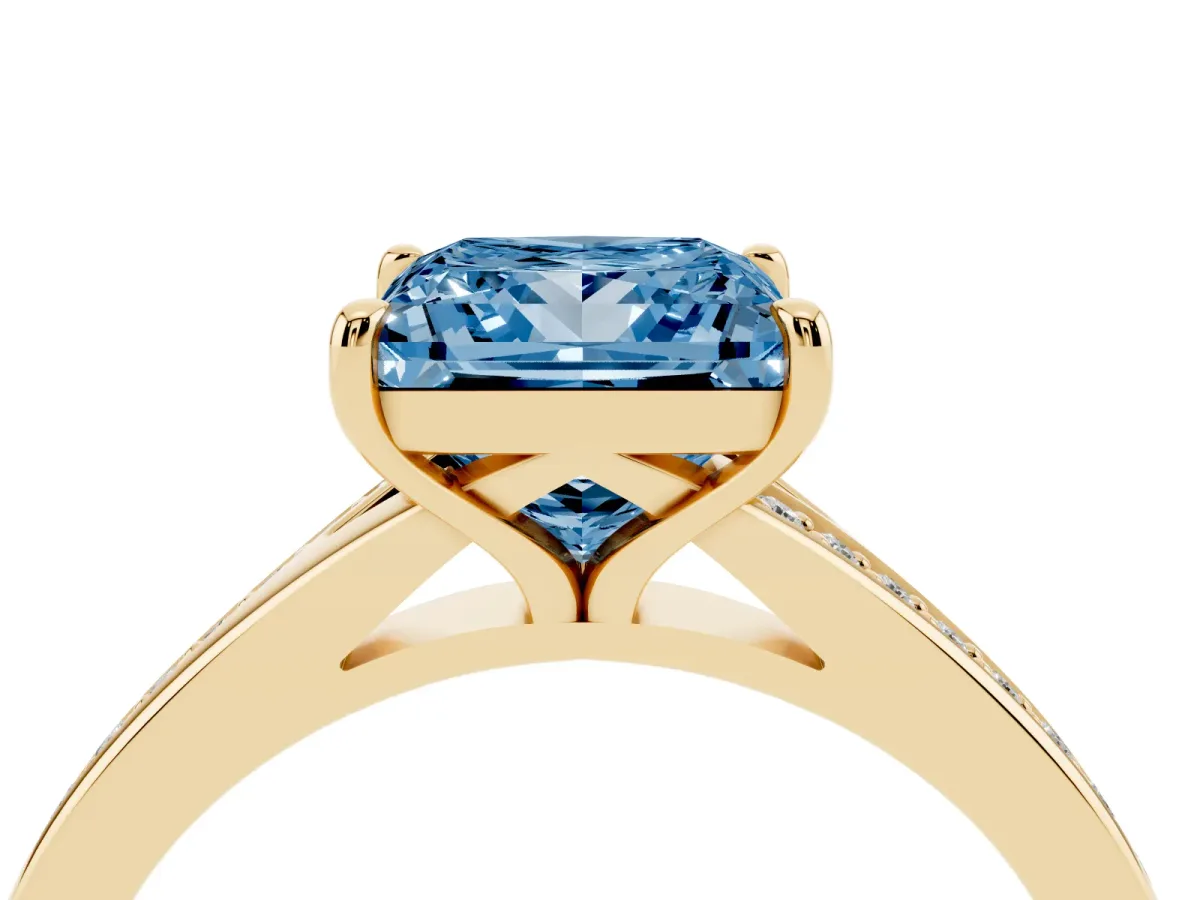 Fancy Blue Princess Cut Diamond Solitaire Ring with Pavé Band and Prong Setting Yellow gold
