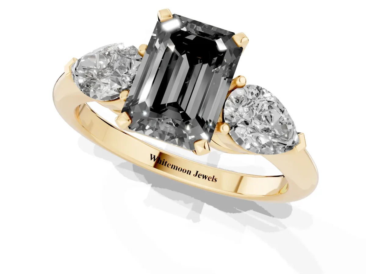 Fancy Black Three-Stone Emerald Cut Diamond Ring with Pear Side Stones and Four-Prong Setting Yellow gold