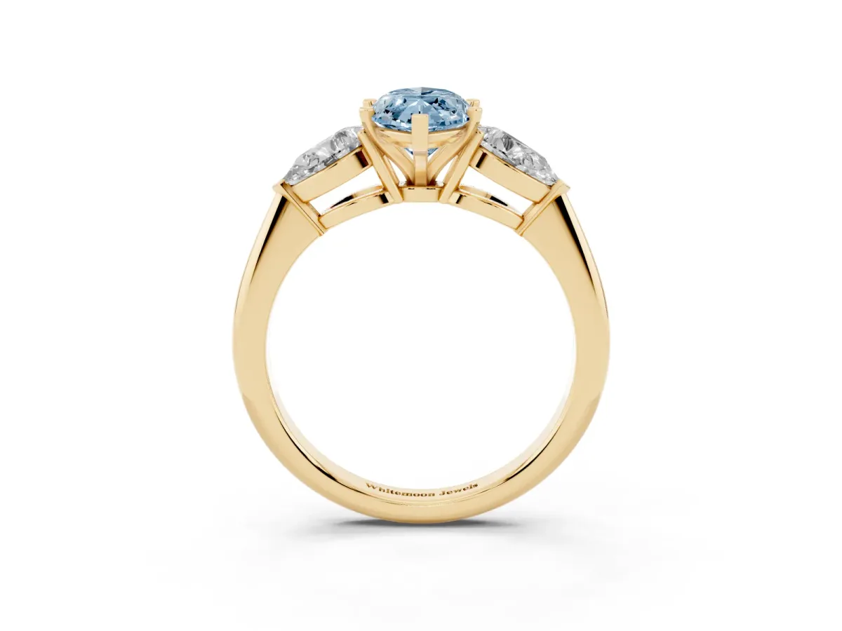 Fancy Blue Three-Stone Marquise Cut Diamond Ring with Pear Side Stones and Four-Prong Setting Yellow gold