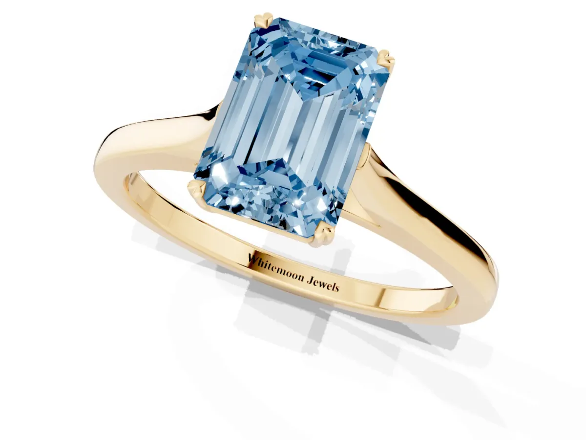 Fancy Blue Emerald Cut Solitaire Heart Prong Engagement Ring with Tapered Band Yellow gold